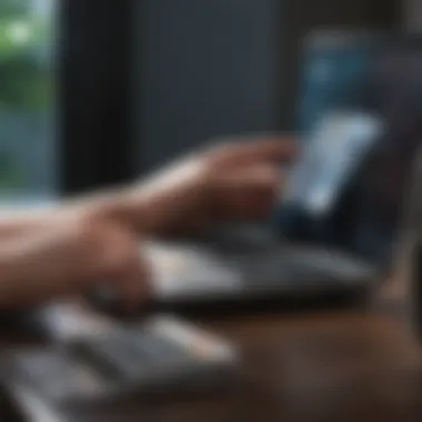 A person analyzing a budget on a laptop next to a credit card